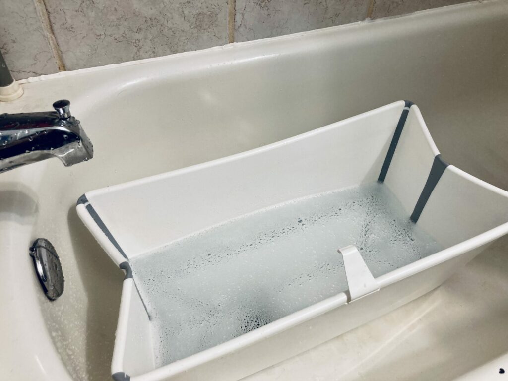 Picture of the Stokke flexi bath inside a standard bath tub.