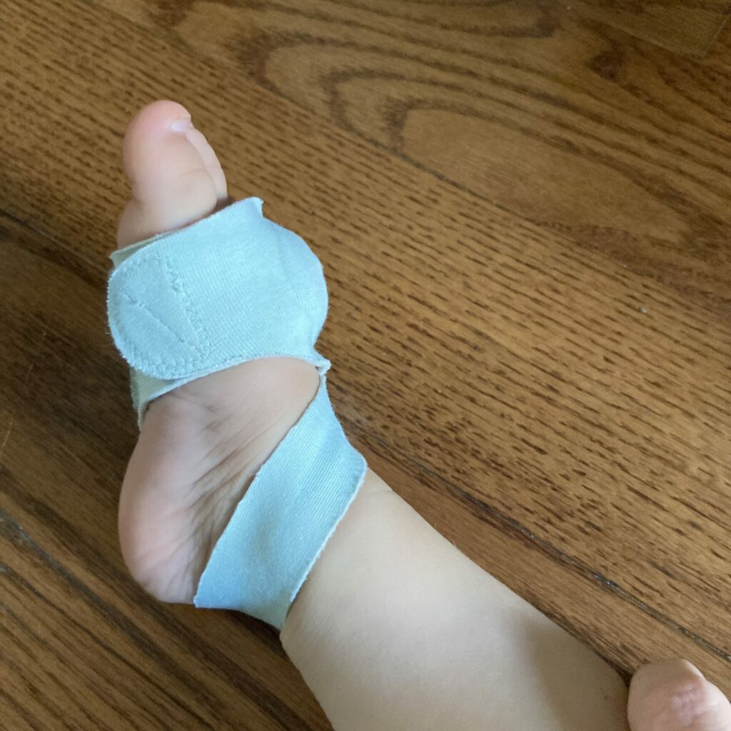 Owlet smart sock on a baby foot