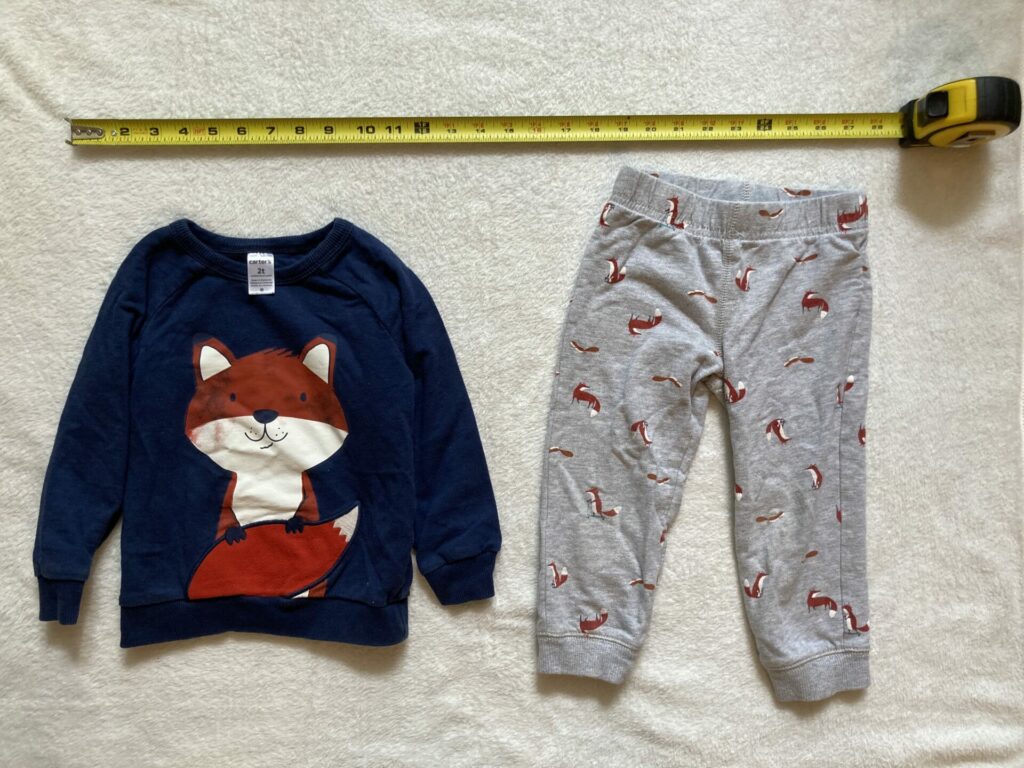 2t shirt and pants with measuring tape to show what size 2T is