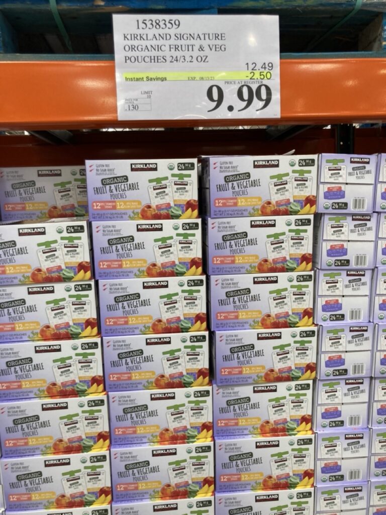 boxes of costco baby food pouches on the shelf with a sales tag above them