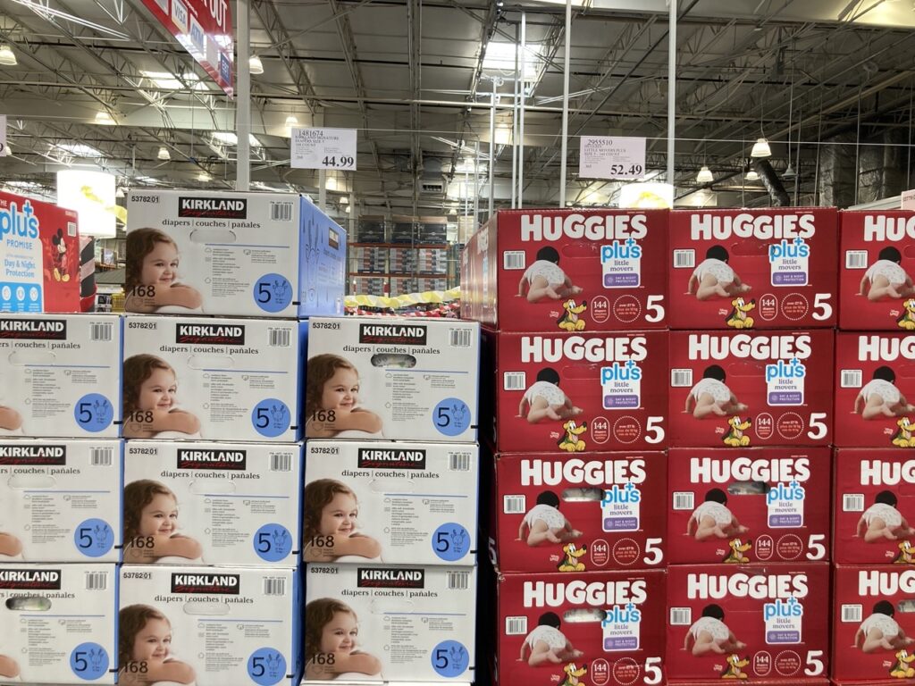 boxes of kirkland diapers and huggies diapers next to each other at the store