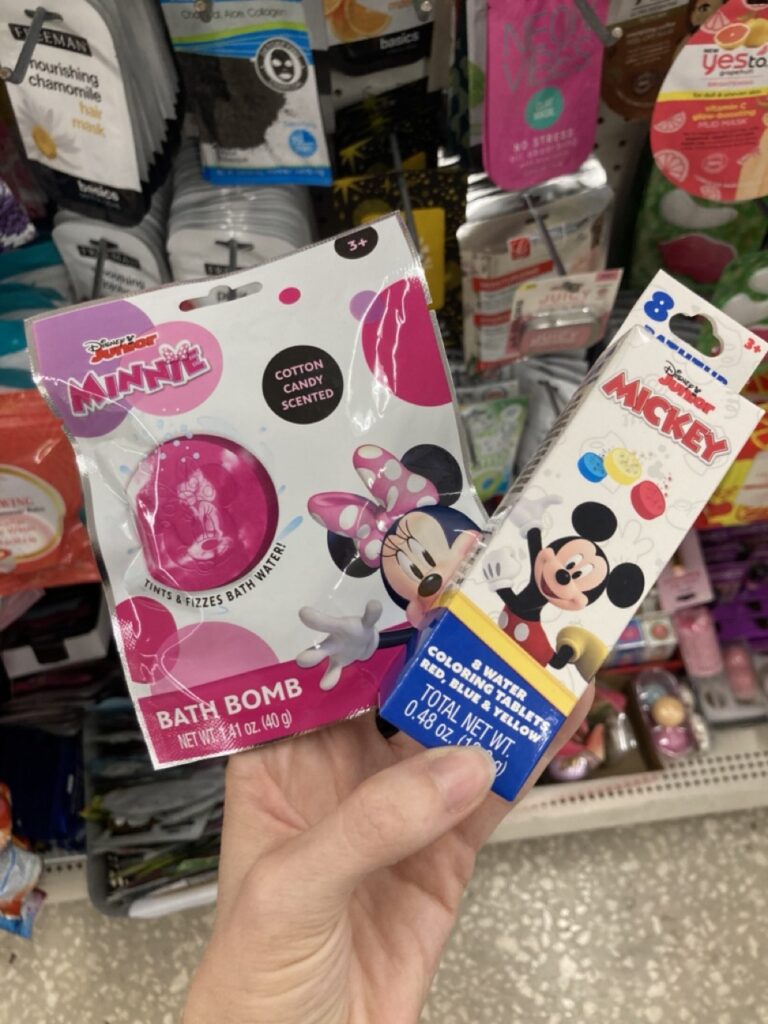 a hand holding mickey and minnie mouse themed bath bombs and color tabs