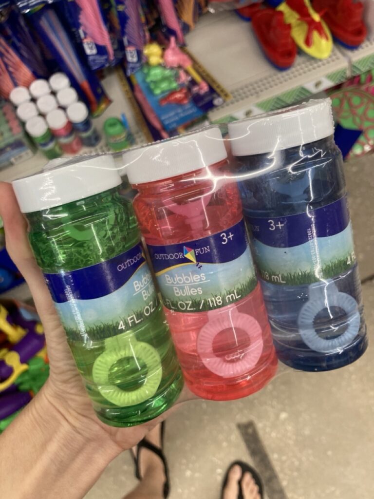 three bottles on bubbles in green, pink and blue