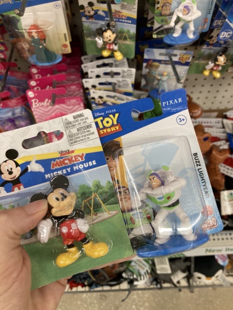 Mickey Mouse and Buzz Lightyear figurines in their packages at the dollar store