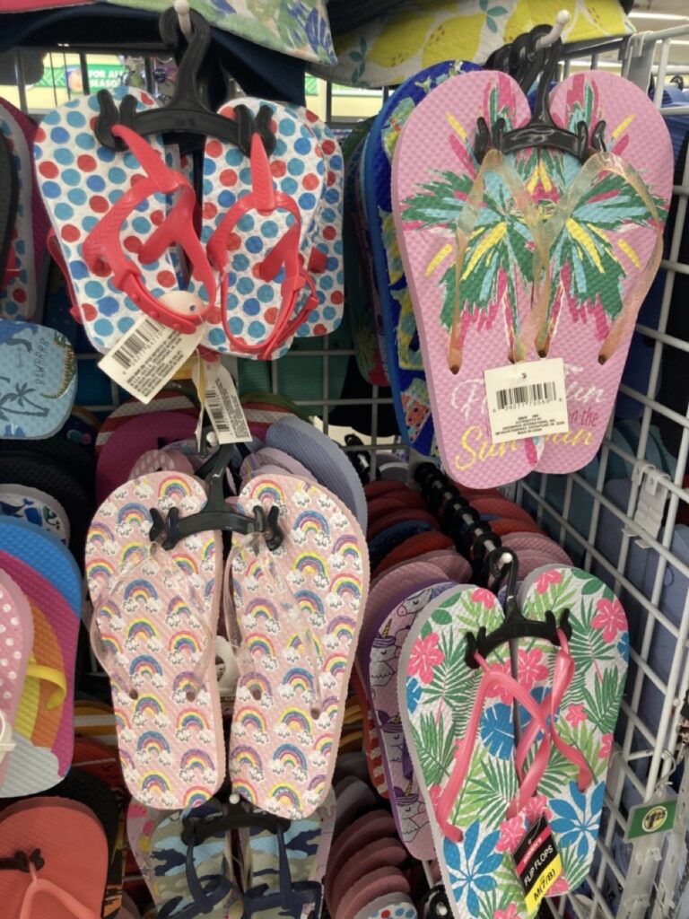 flip flops hanging from the shelf at the dollar tree