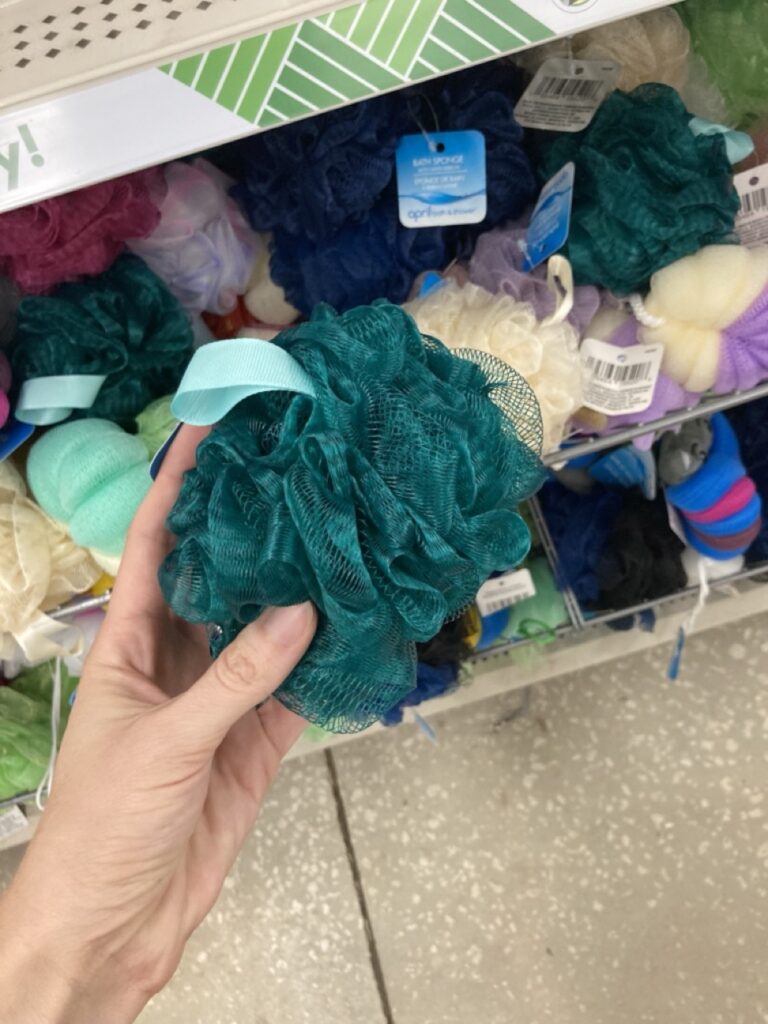 a hand holding a puff loofah at the store