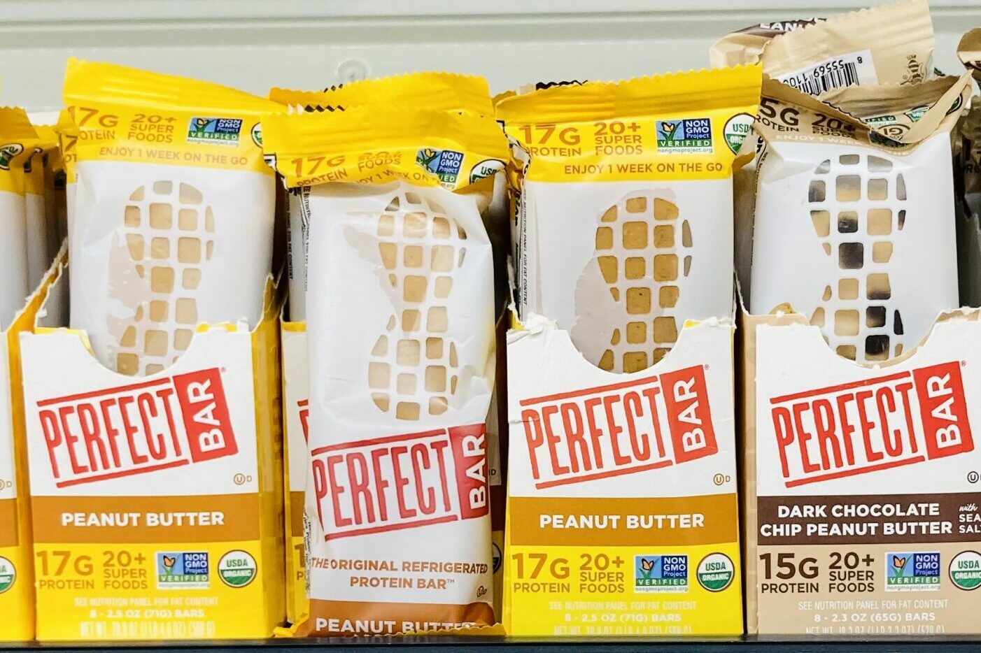 boxes of Perfect Bars in peanut butter and dark chocolate chip peanut butter flavors. 