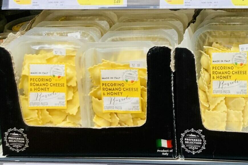 packs of pecorino romano cheese and honey ravioli on the shelf at the grocery store.