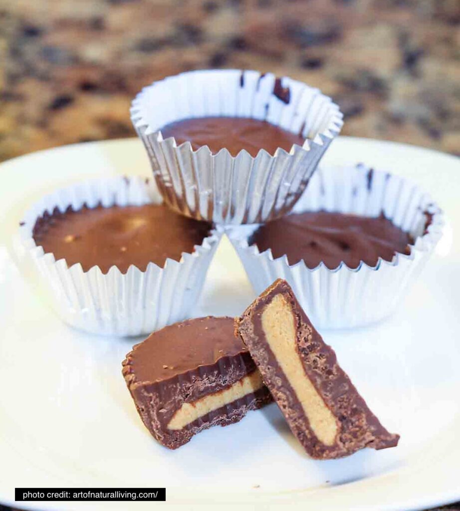 Two cut-in-half chocolate peanut butter cups with three peanut butter cups in mini muffin tin wraps stacked behind them.