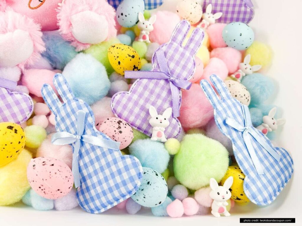 There are little buffalo plaid bunnies, plastic bunnies, easter eggs and pom pons in a bin