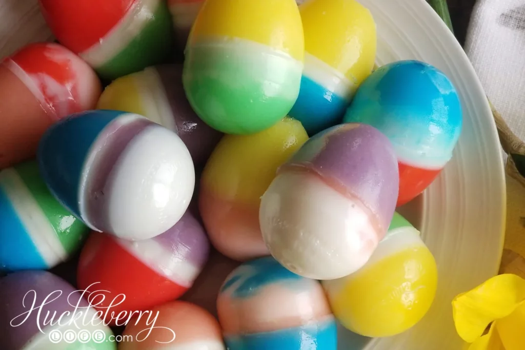 A bowl full of multi-colored jell-o easter eggs.