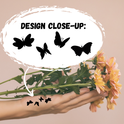 a hand with a side hand tattoo with four butterflies in black