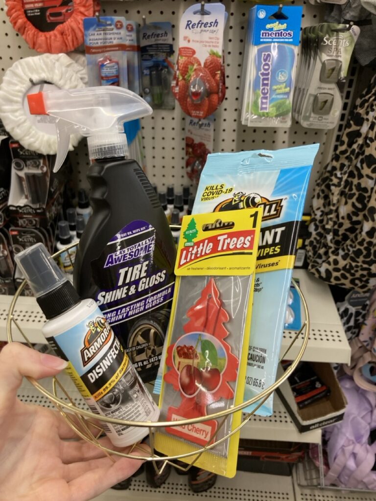 a basket of car supplies like air fresheners and cleaners