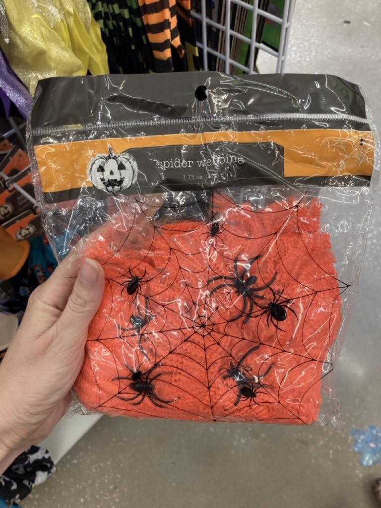 package of orange fake spider web decoration