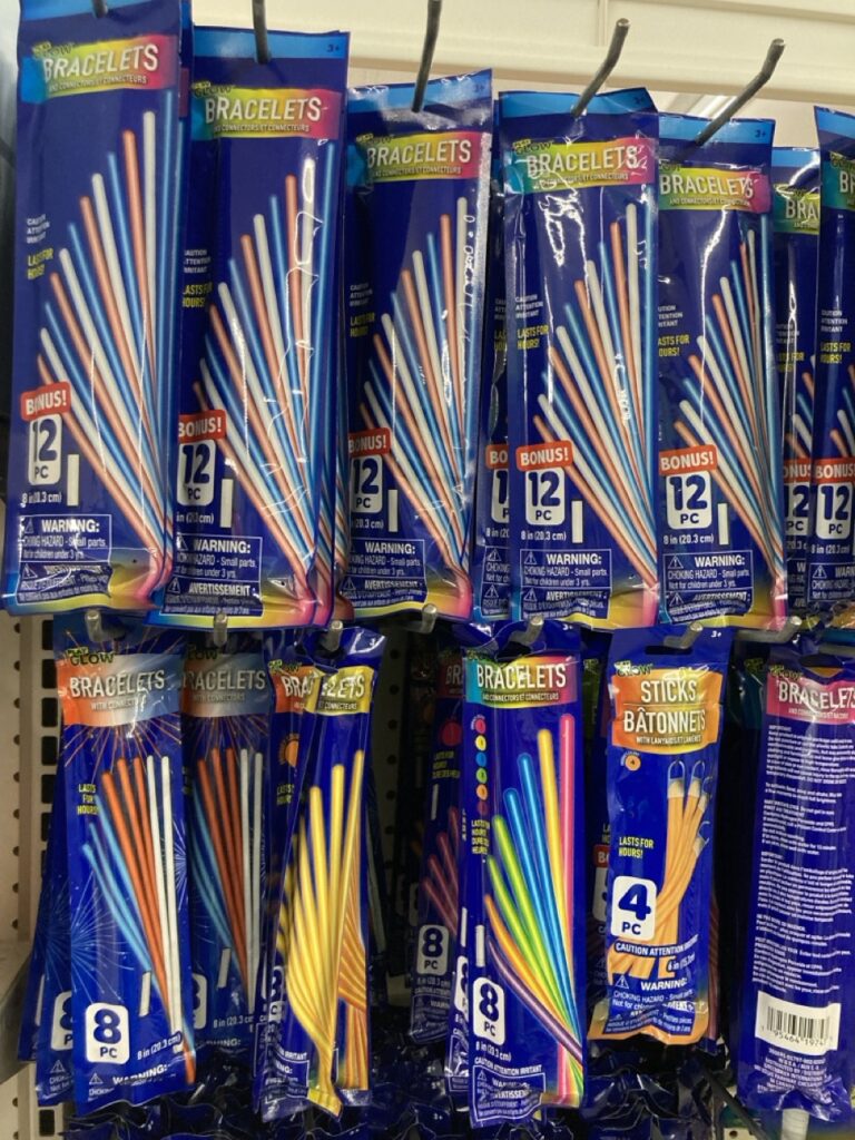 packs of glow sticks hanging on the shelf at a store