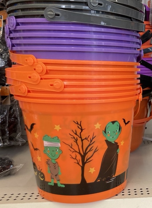 a stack of halloween themed buckets in orange, purple and black