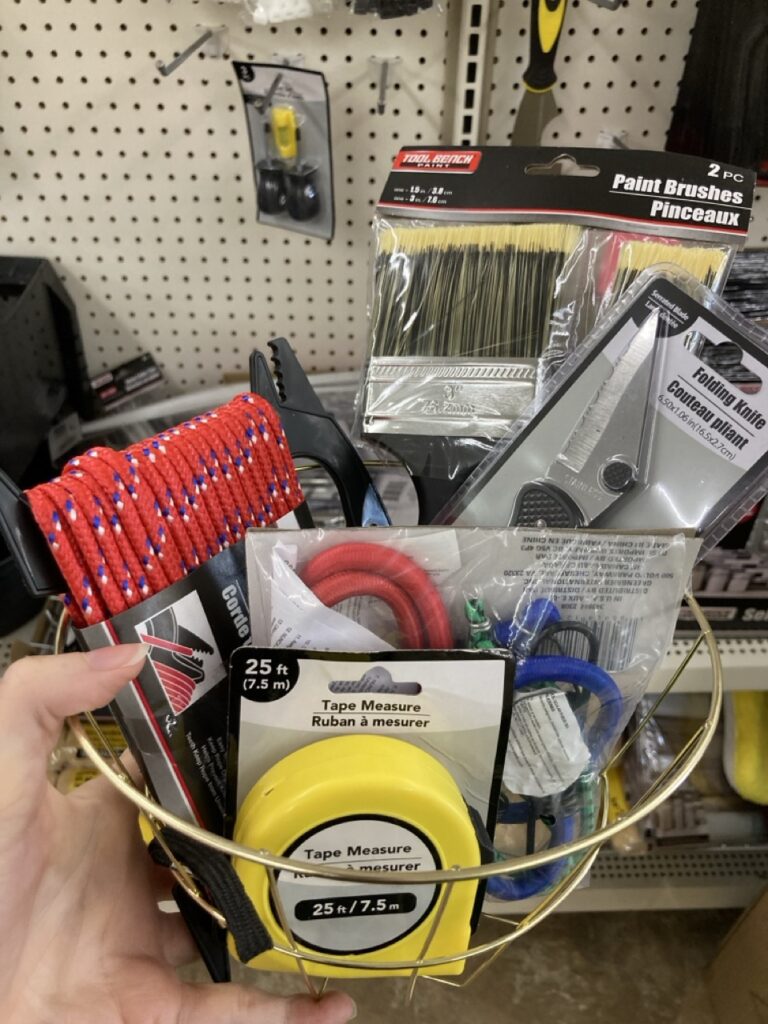 a basket of small tools like a measuring tape, rope and zip ties