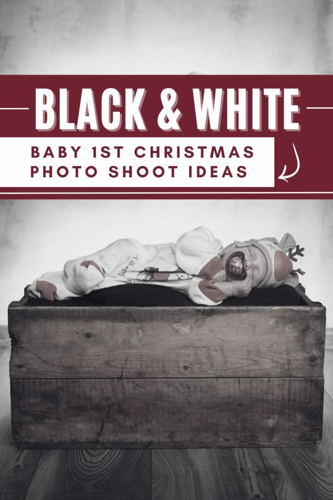 black and white picture of a baby on a chest sleeping in a reindeer costume