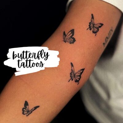 small butterfly tattoos up an arm