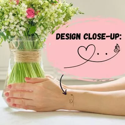 woman's arms and hands holding a vase of flowers with a butterfly and heart tattoo on the outer wrist. overlay that says "design close up" with a zoom in on the butterfly tattoo design