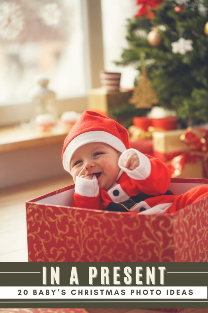 baby in a santa costume in a gift box with a tree in the background. text says: in a present, 20 baby's christmas photo ideas
