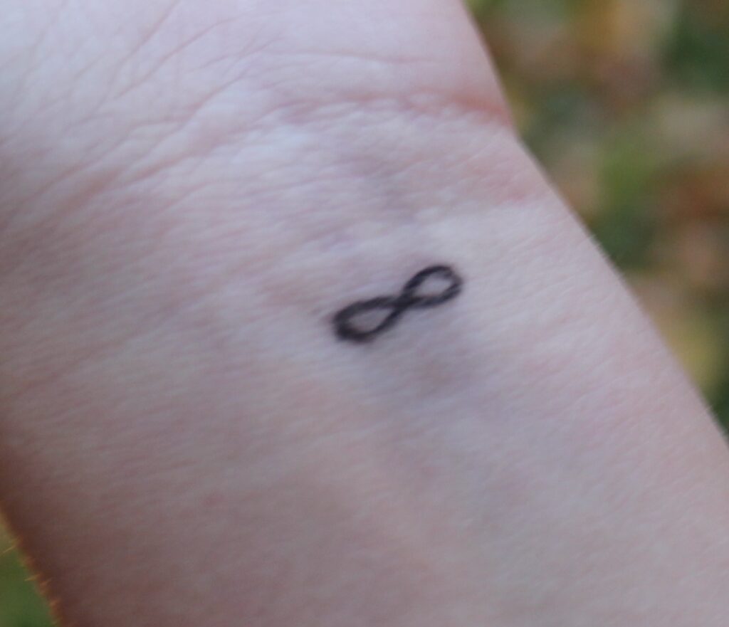 very small infinity symbol wrist tattoo