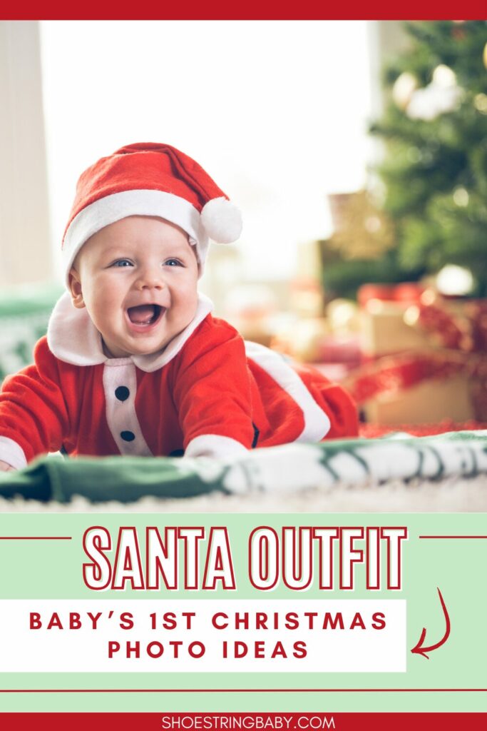 smiling baby in a santa costume with a christmas tree and presents in the background