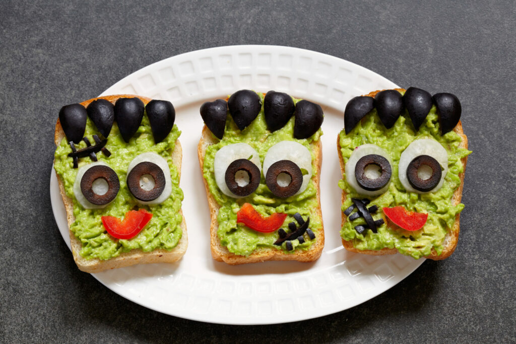 avocado toast made to look like monster faces with olives
