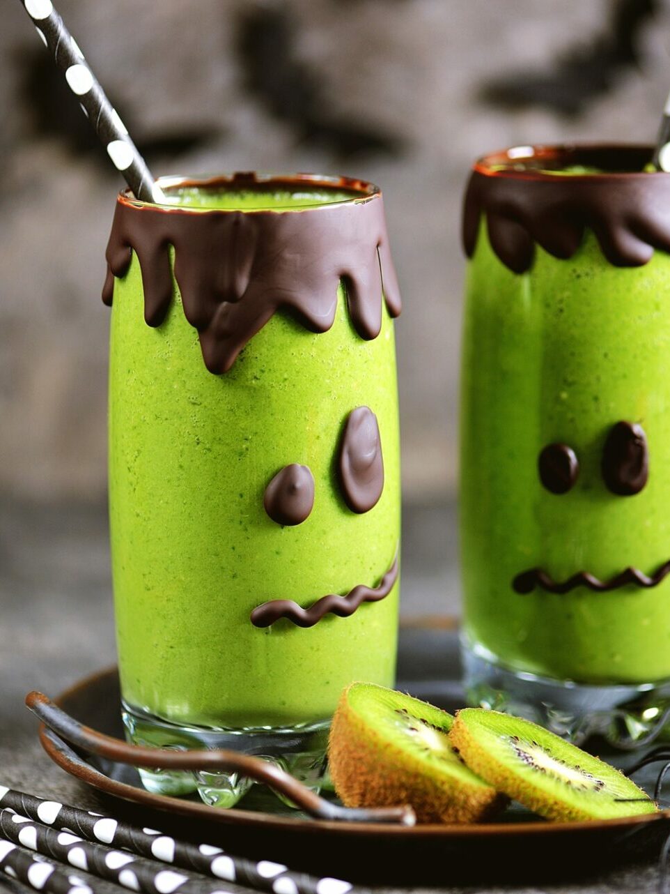 green smoothies made to look like monster faces on the glasses