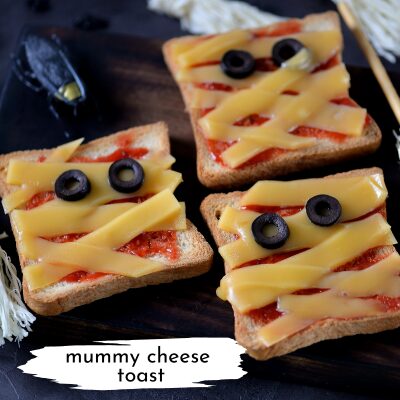 cheese toast made to look like mummies with olive slices for eyes
