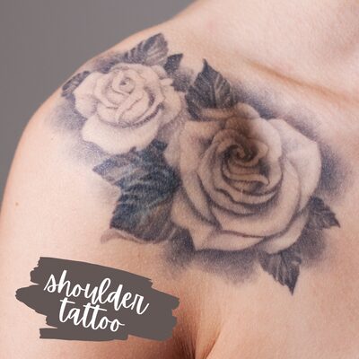 two black rose tattoos on the shoulder