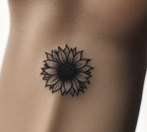 a small wrist tattoo of a sunflower