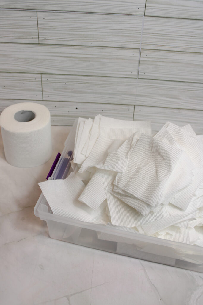 Shredded toilet paper on a clear plastic container.
