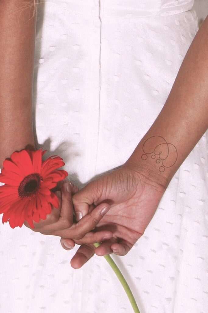 Tattoo of heart symbolizing family.