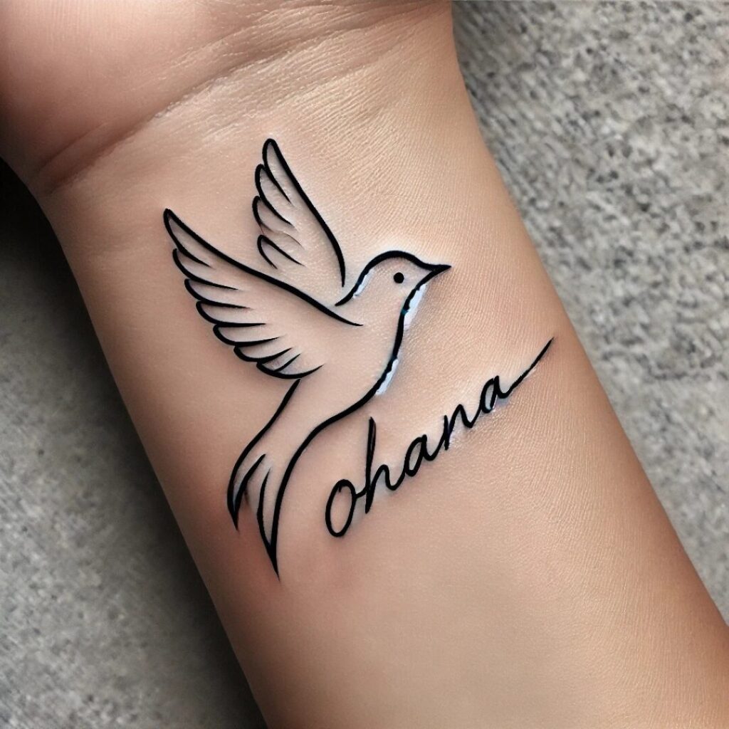 Tattoo of a bird on the wrist with a cursive "Ohana" tattoo underneath.