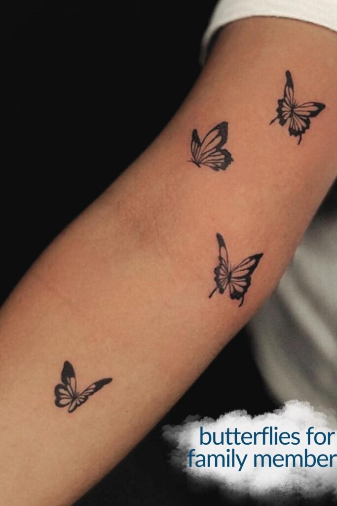Four butterfly tattoo on arm.
