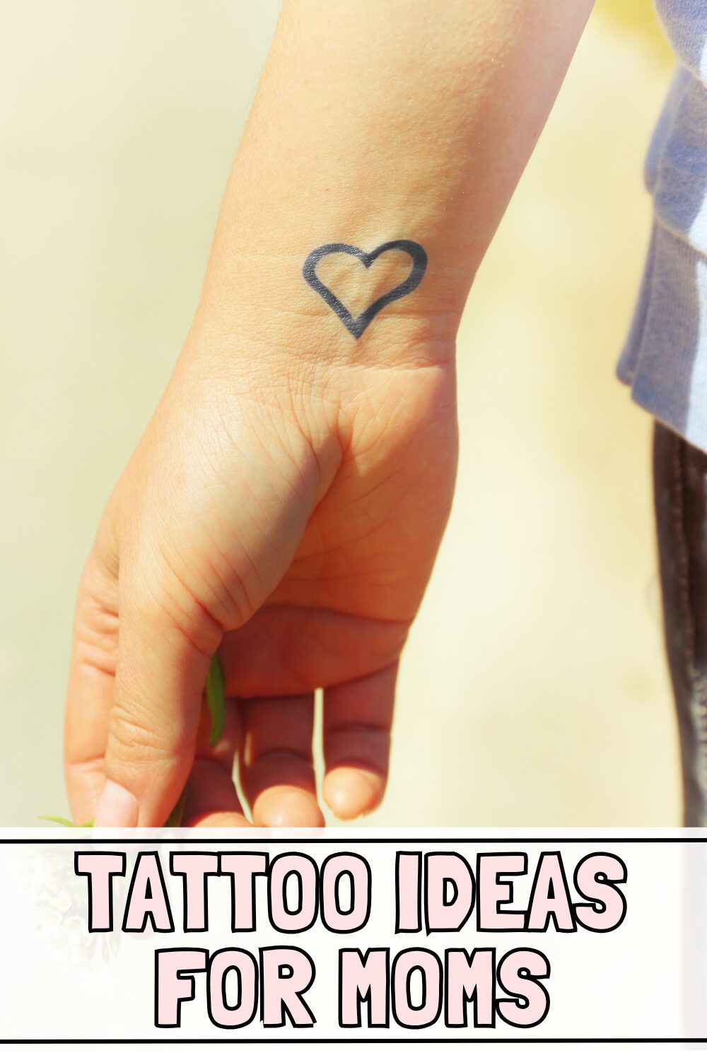 heart on the wrist tattoo and text underneath that says tattoo ideas for moms
